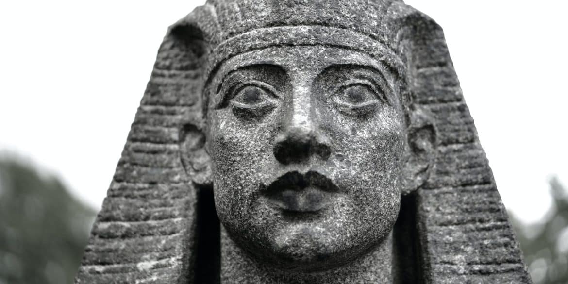 a black and white photo of a statue of a pharaoh